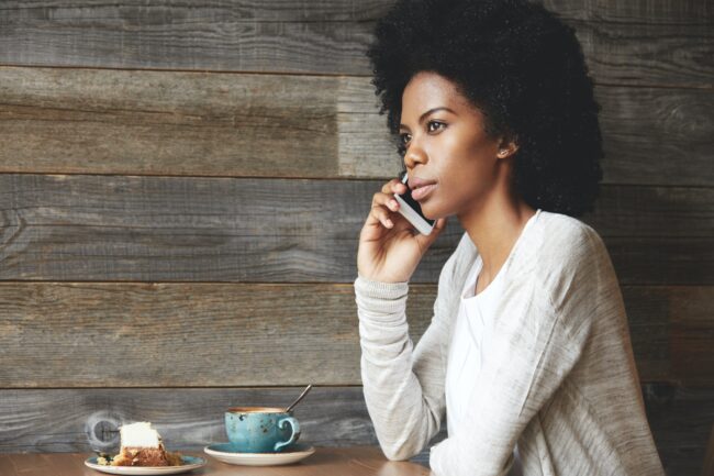 People and lifestyle concept. Portrait of attractive African female office worker with stylish Afro